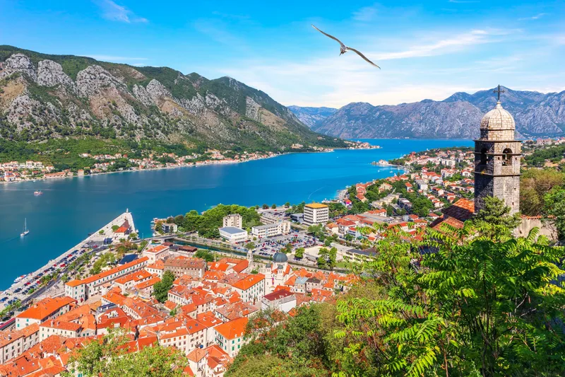 View on the bay of kotor, church of our lady of remedy and the old town roofs, montenegro.