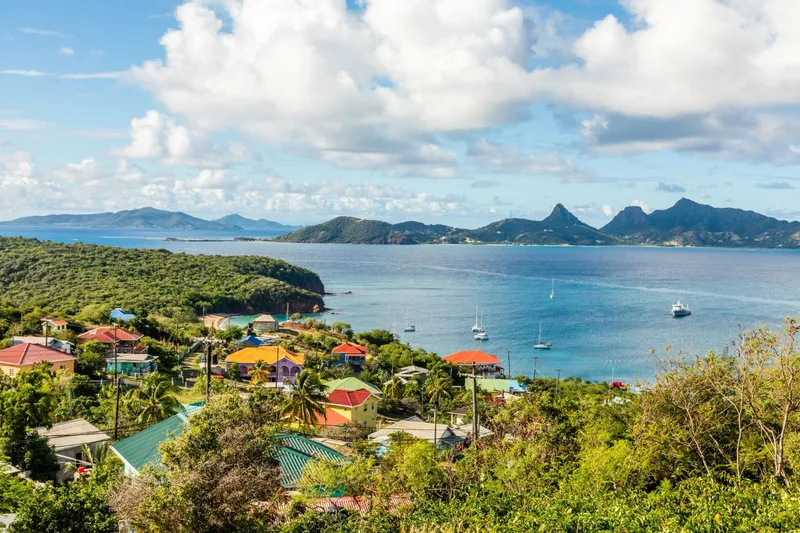 Residential houses at the bay mayreau island panorama with union island in the background saint vincent and the grenadines