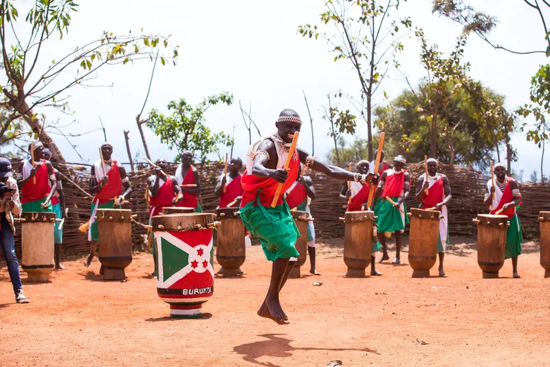 Live outdoor performance by traditional Burundian drummers in cultural costumes, celebrating heritage.